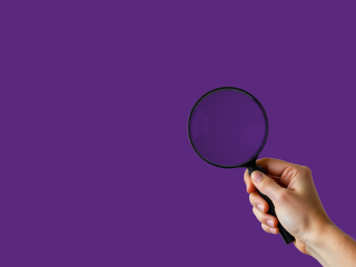 Magnifying glass on purple background