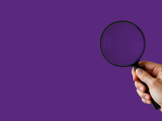 Magnifying glass on purple background